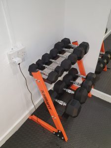 Side view of the Customers Mirafit Dumbbell Set & Weight Rack in a home gym