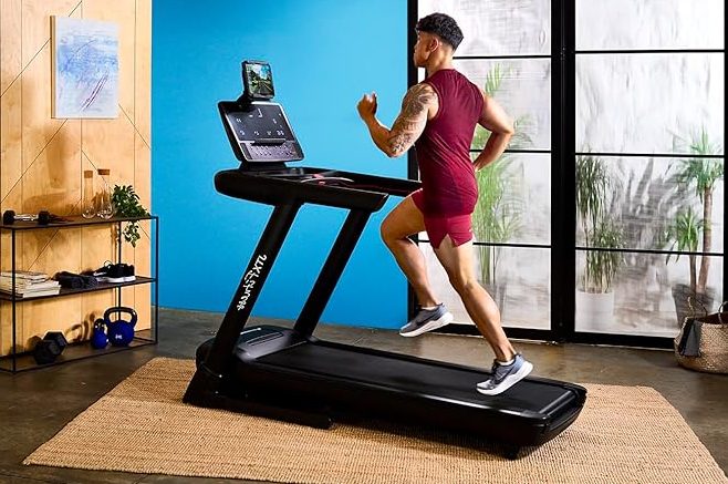 A man using the JTX Sprint-8 Pro Foldable Treadmill