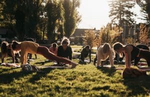 This Pilates group is using the outdoors for their Pilates sessions without any pilates machines or equipment apart from a mat and their own bodyweight.