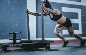 This lady is doing a WOD in a CrossFit Gym - we cover WOD and workouts in our CrossFit Gym Blog