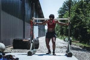Woman doing Strongman training outdoors. We covered the benefits of doing Strongman training both indoors and outdoors in our Strongman Blog